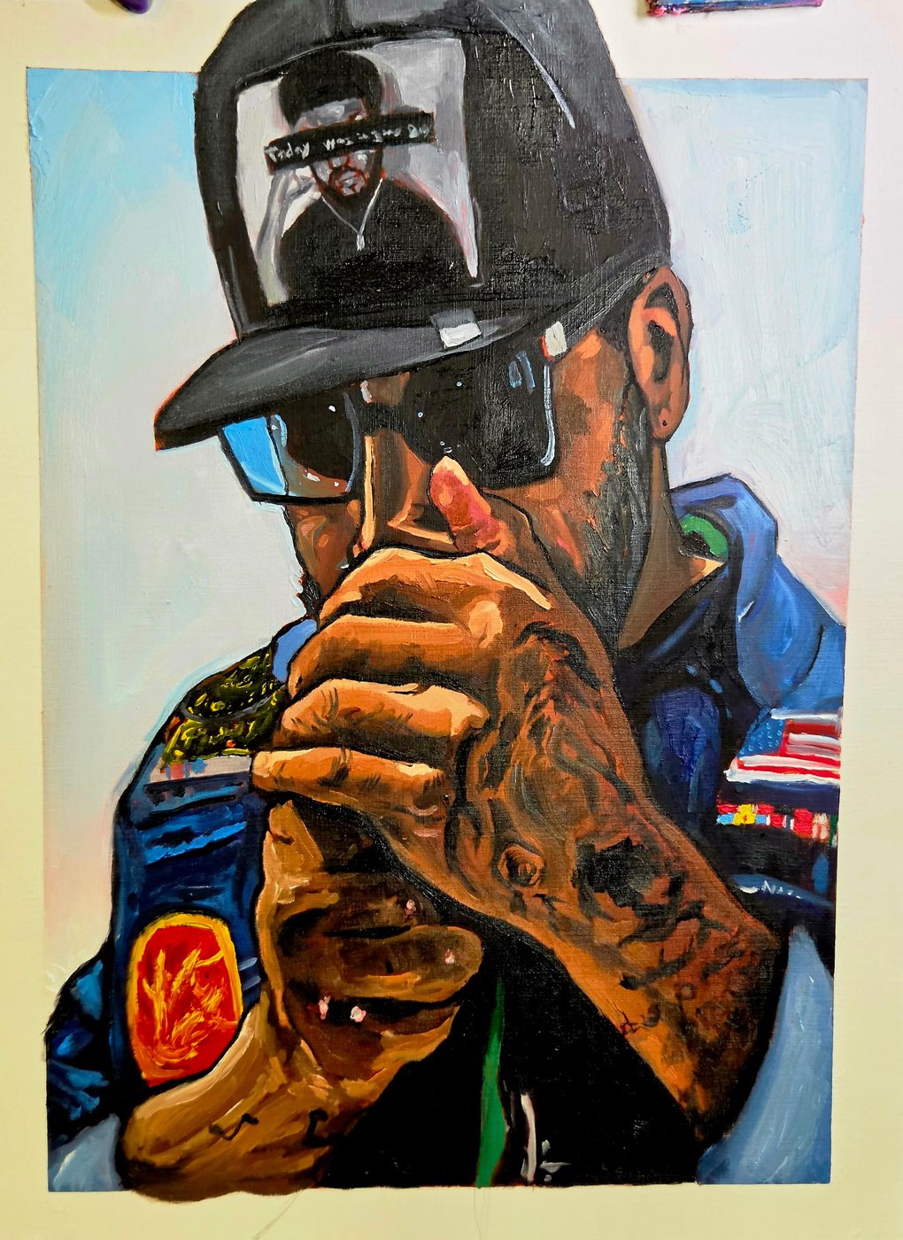 Portrait of a man in a trucker hat holding up a phone reflection