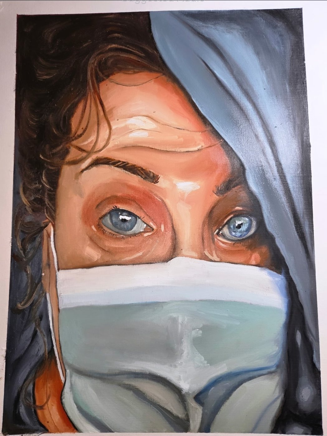 Close portrait of eyes above a surgical mask