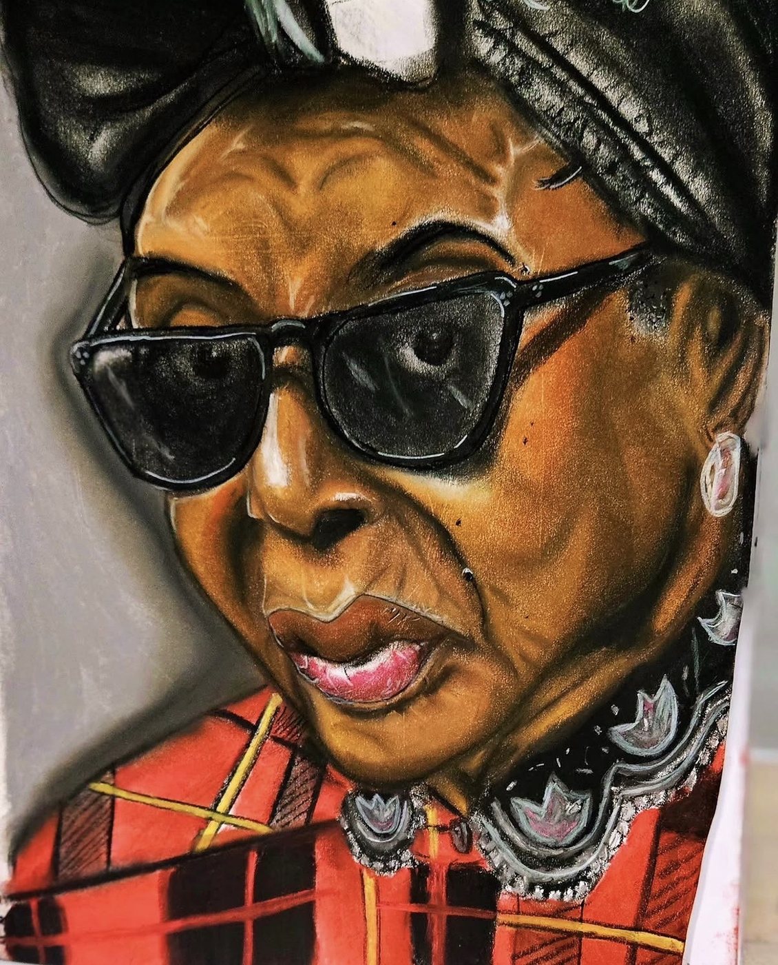 Portrait of a woman in sunglasses and a red plaid coat